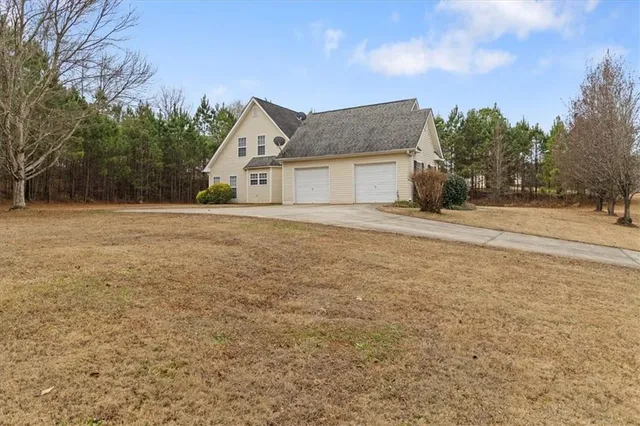 a front view of a house with a yard and trees