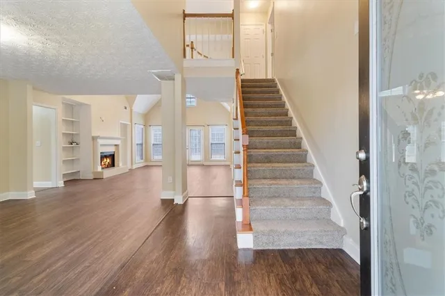 a view of entryway and hall with wooden floor
