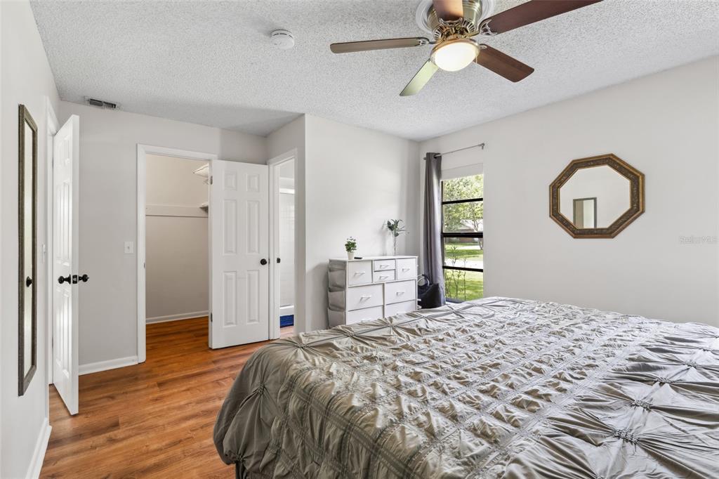 1228 Southwest 75th Drive Gainesville, FL 32607 - Photo 11 of 17 a bedroom with a bed and a chandelier