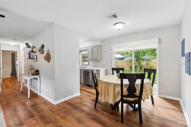 a view of a dining room with furniture window and wooden floor