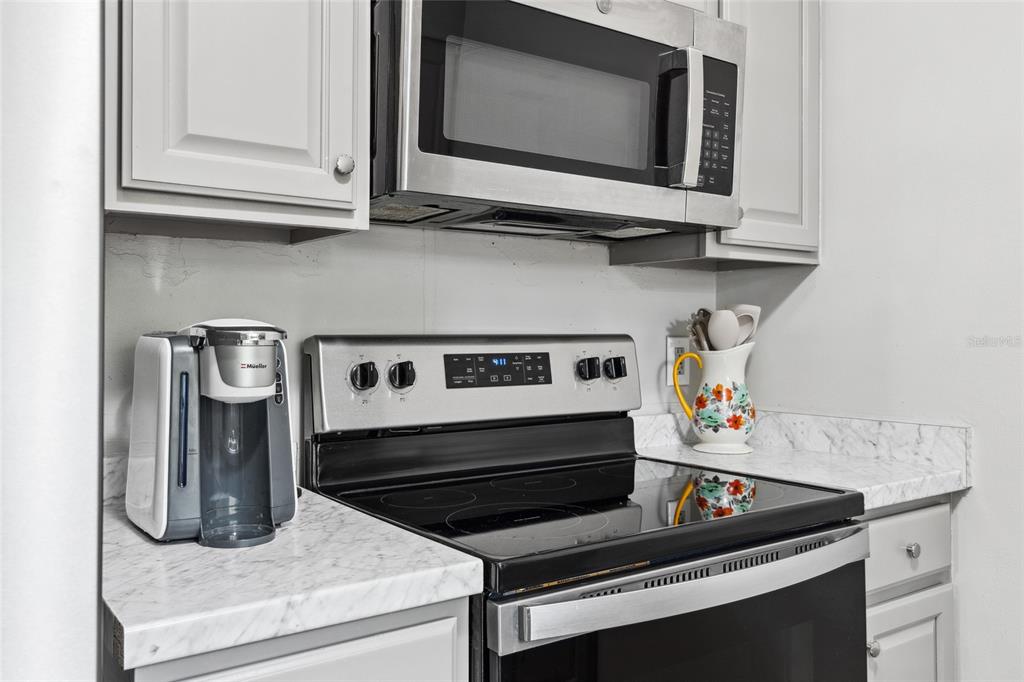1228 Southwest 75th Drive Gainesville, FL 32607 - Photo 14 of 17 a kitchen with a stove and a microwave
