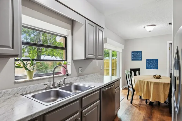 a kitchen with a sink and a large window