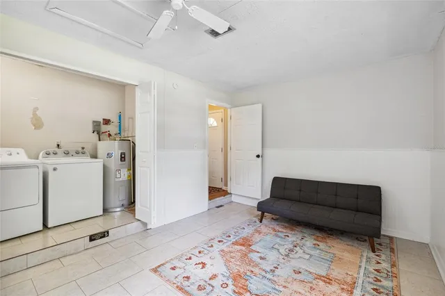 a living room with furniture and a dresser
