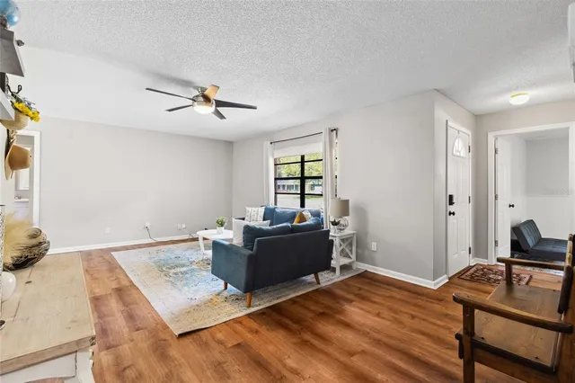 a living room with furniture and wooden floor