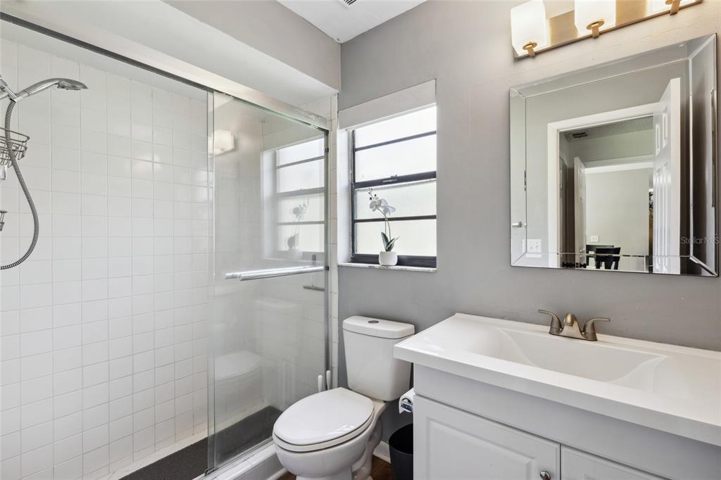 1228 Southwest 75th Drive Gainesville, FL 32607 - Photo 10 of 17 a bathroom with a sink toilet vanity and shower