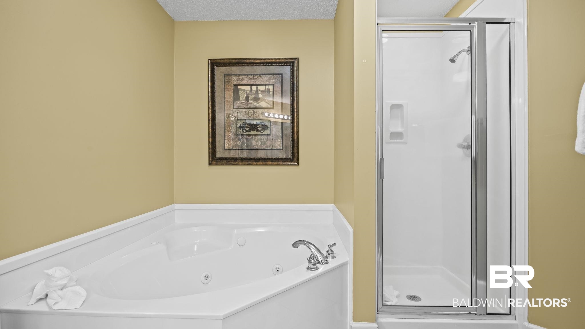 27580 Canal Road, Unit 214 BS 62 Orange Beach, AL 36561 - Photo 10 of 23 Full bathroom with a shower stall, a tub with jets, and a textured ceiling