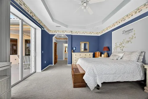 a bed room with a bed and a chandelier