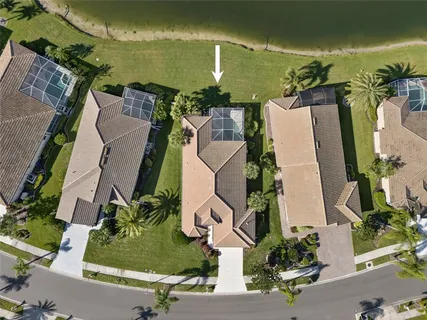 an aerial view of a house with swimming pool and outdoor space