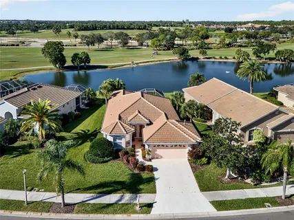 an aerial view of a house with a lake view