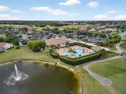 an aerial view of ocean and residential houses with outdoor space