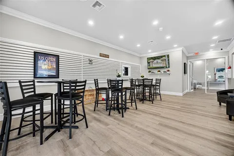 a dining room with furniture window and wooden floor