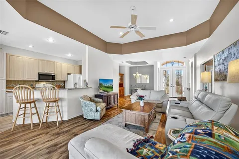 a living room with furniture and kitchen view