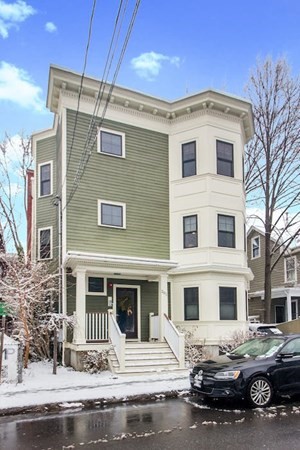 a front view of a building with parking space