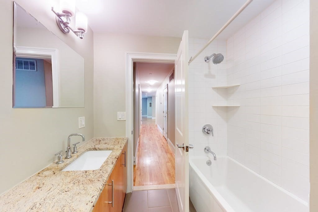 201 Pearl Street, Unit 2 Cambridge, MA 02139 - Photo 13 of 16 a bathroom with a tub sink and mirror