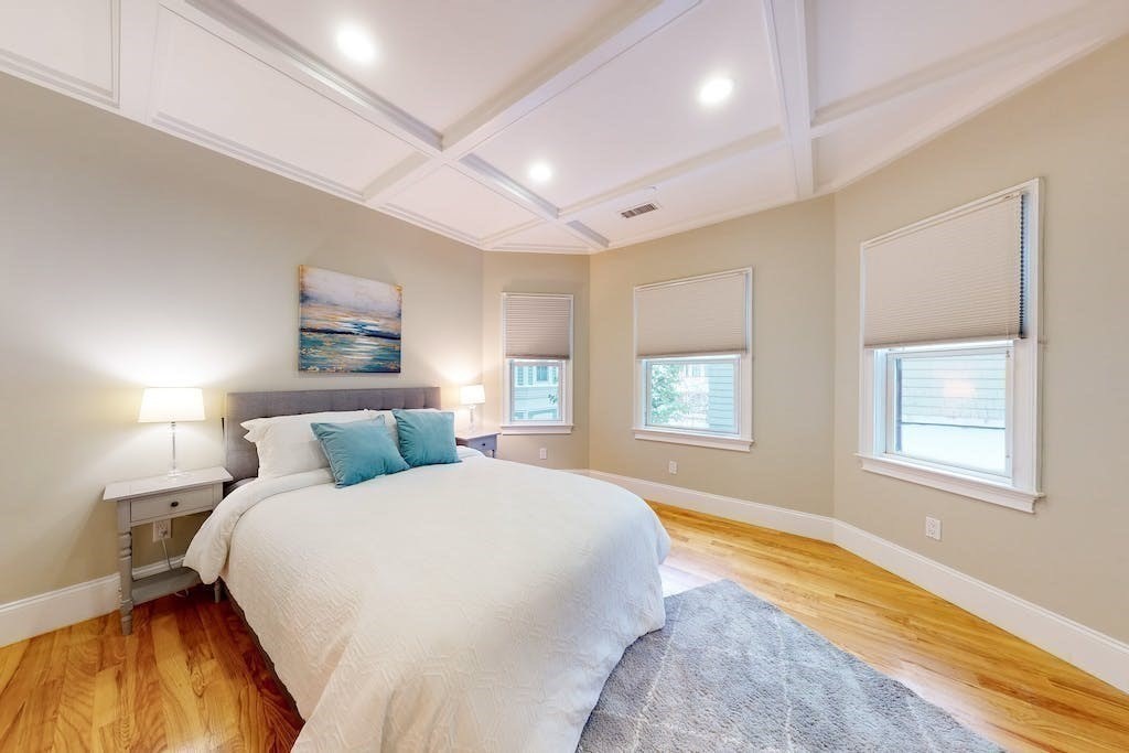 201 Pearl Street, Unit 2 Cambridge, MA 02139 - Photo 9 of 16 a spacious bedroom with a bed and a window