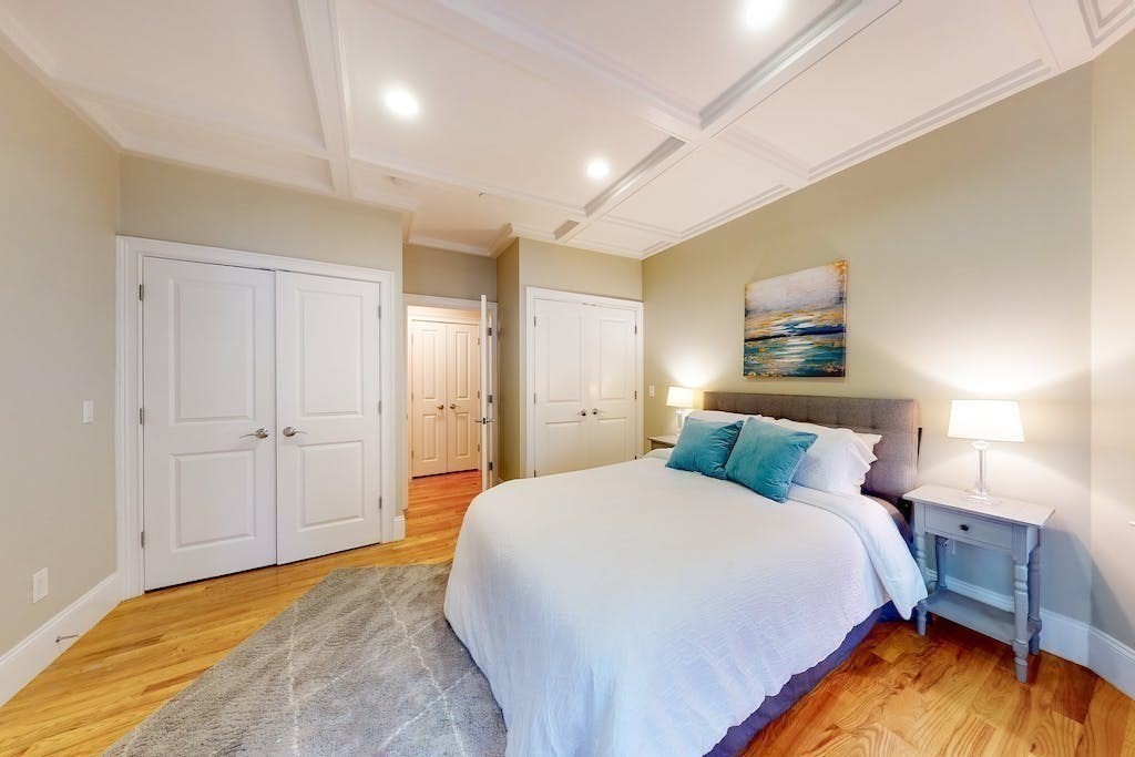 201 Pearl Street, Unit 2 Cambridge, MA 02139 - Photo 10 of 16 a bedroom with a bed and a night stand