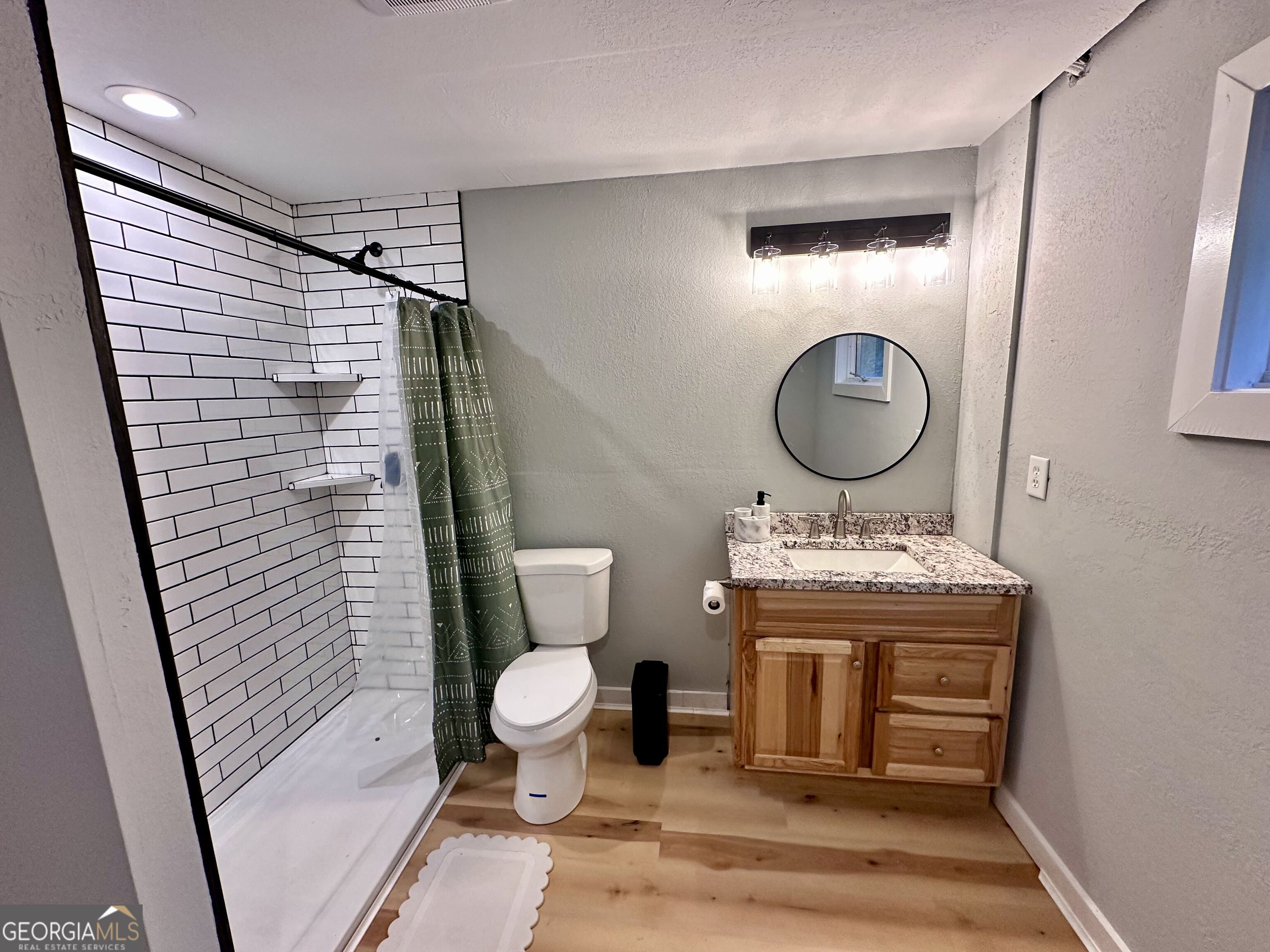 2769 Bean Creek Road Sautee Nacoochee, GA 30571 - Photo 22 of 33 a bathroom with a toilet a sink and a mirror