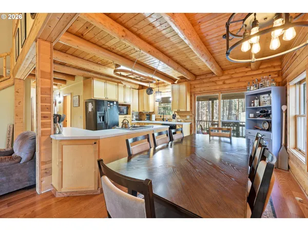 a dining room with furniture and a floor to ceiling window