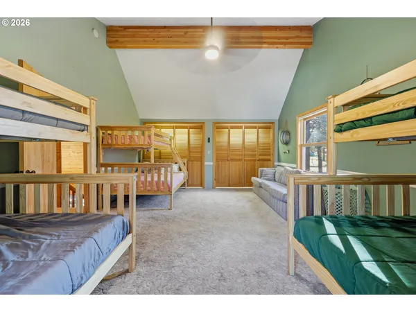 a bedroom with a bed and a large window