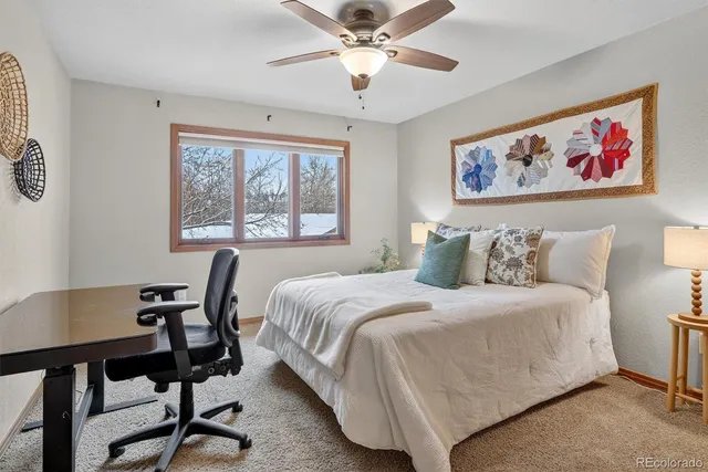 a bedroom with a bed and a painting on the wall