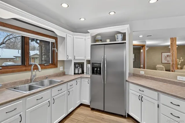 a modern kitchen with stainless steel appliances granite countertop a refrigerator and a sink