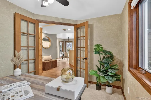 a living room with furniture and a potted plant