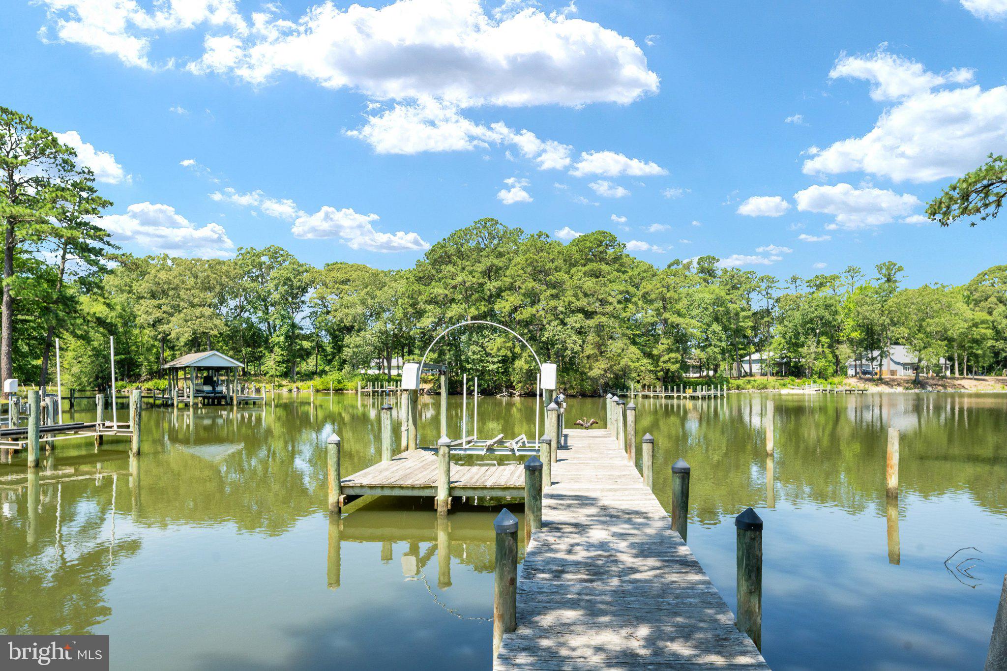 279 Harbor Drive Reedville, VA 22539 - Photo 76 of 97 Serene dock under blue skies.
