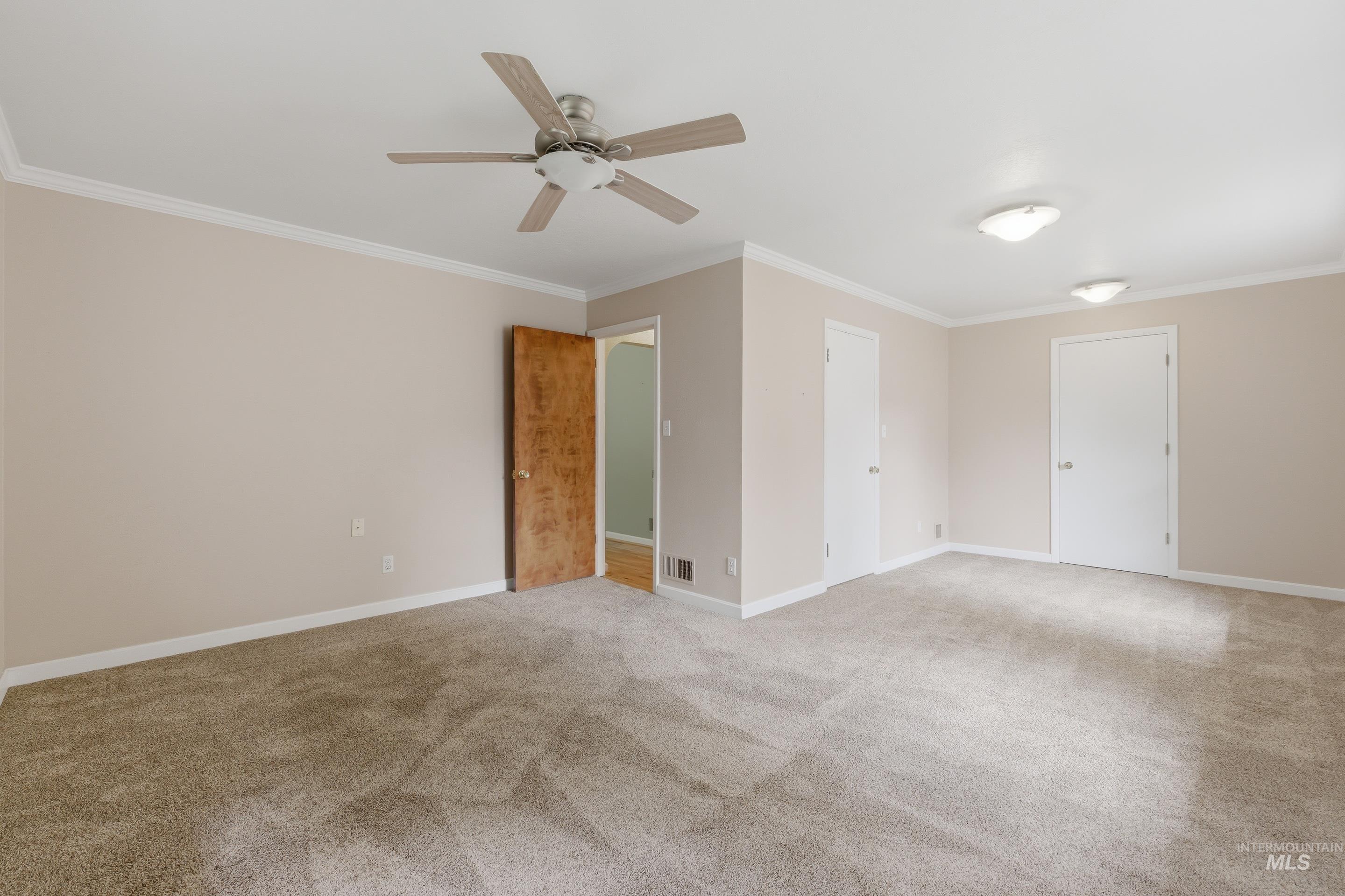504 West Howe Street Boise, ID 83706 - Photo 24 of 47 Spacious room featuring neutral carpeting, a ceiling fan with light, and multiple flush-mount light fixtures