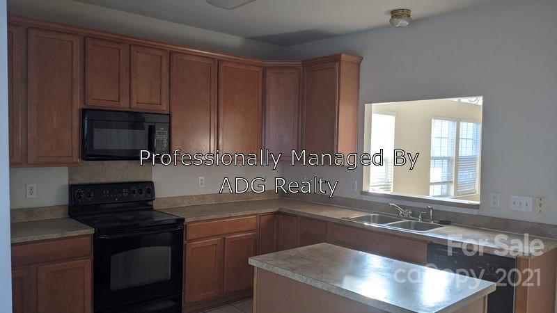 6336 Trotters Ridge Road Charlotte, NC 28227 - Photo 5 of 7 a kitchen with a sink stove and microwave