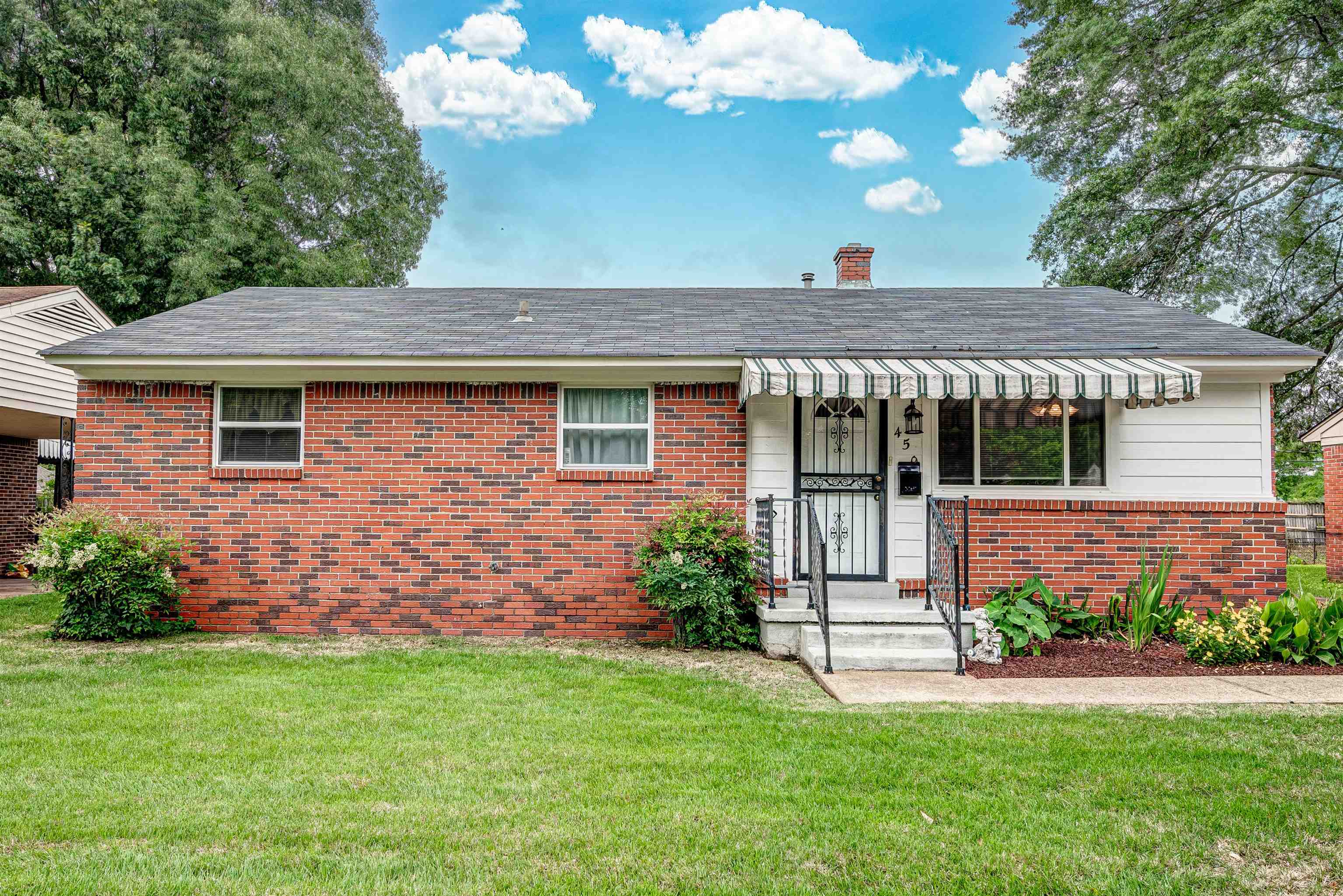450 Malboro Road Memphis, TN 38120 - Photo 1 of 16 a front view of a house with a garden