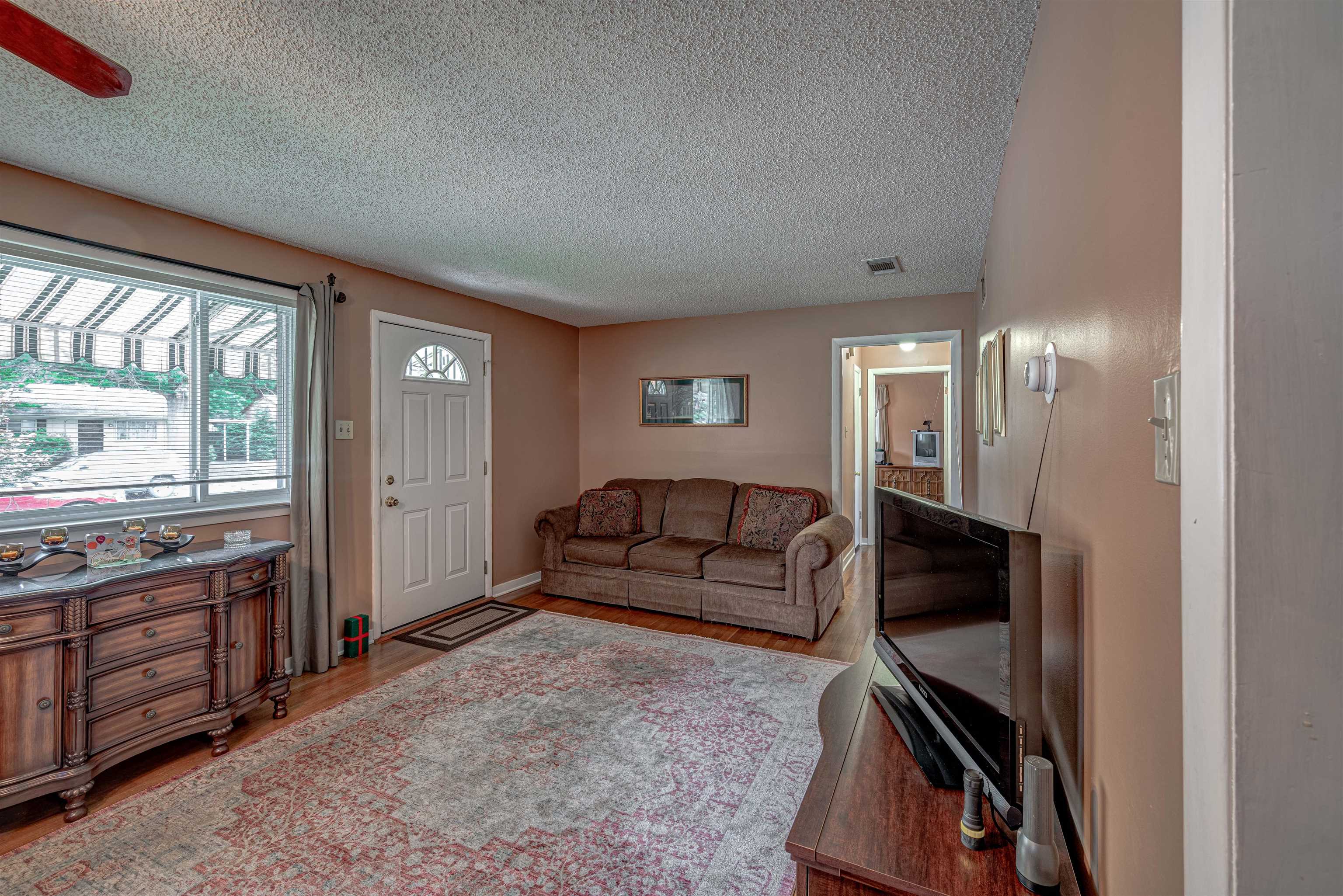 450 Malboro Road Memphis, TN 38120 - Photo 3 of 16 a living room with furniture a flat screen tv and a window