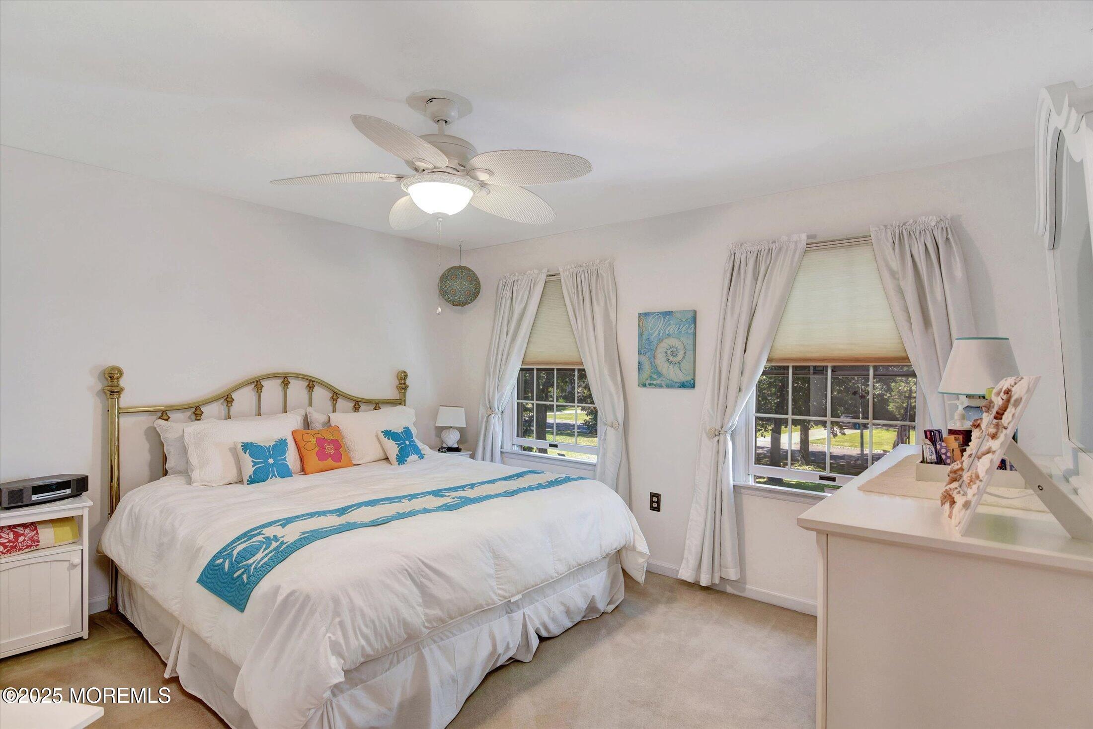 14 Bittersweet Drive Jackson, NJ 08527 - Photo 23 of 43 a bedroom with a large bed and a chandelier