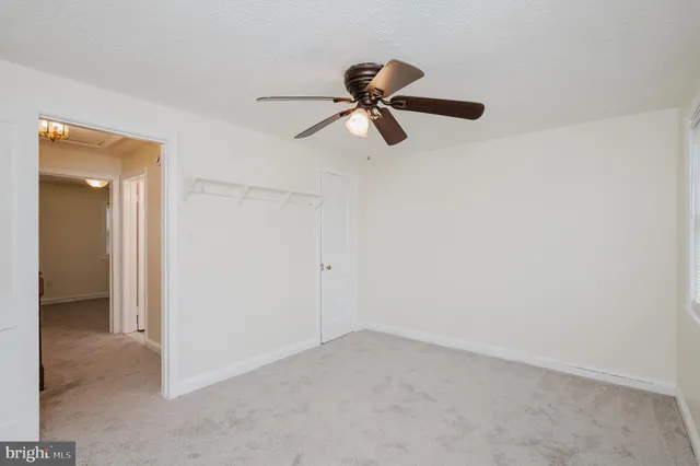 a view of a room with a hanging light and closet