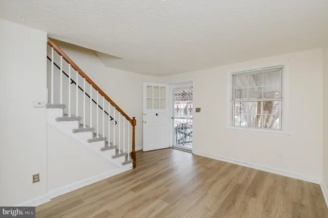 a view of entryway with stairs and wooden floor