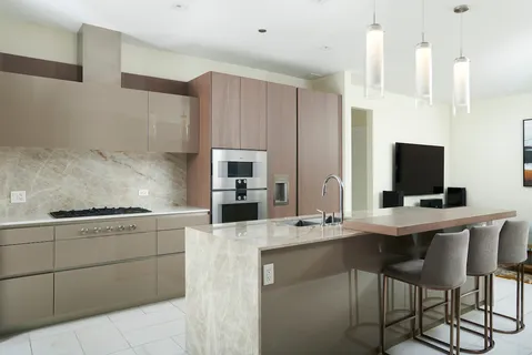 a kitchen with stainless steel appliances kitchen island granite countertop a sink and cabinets