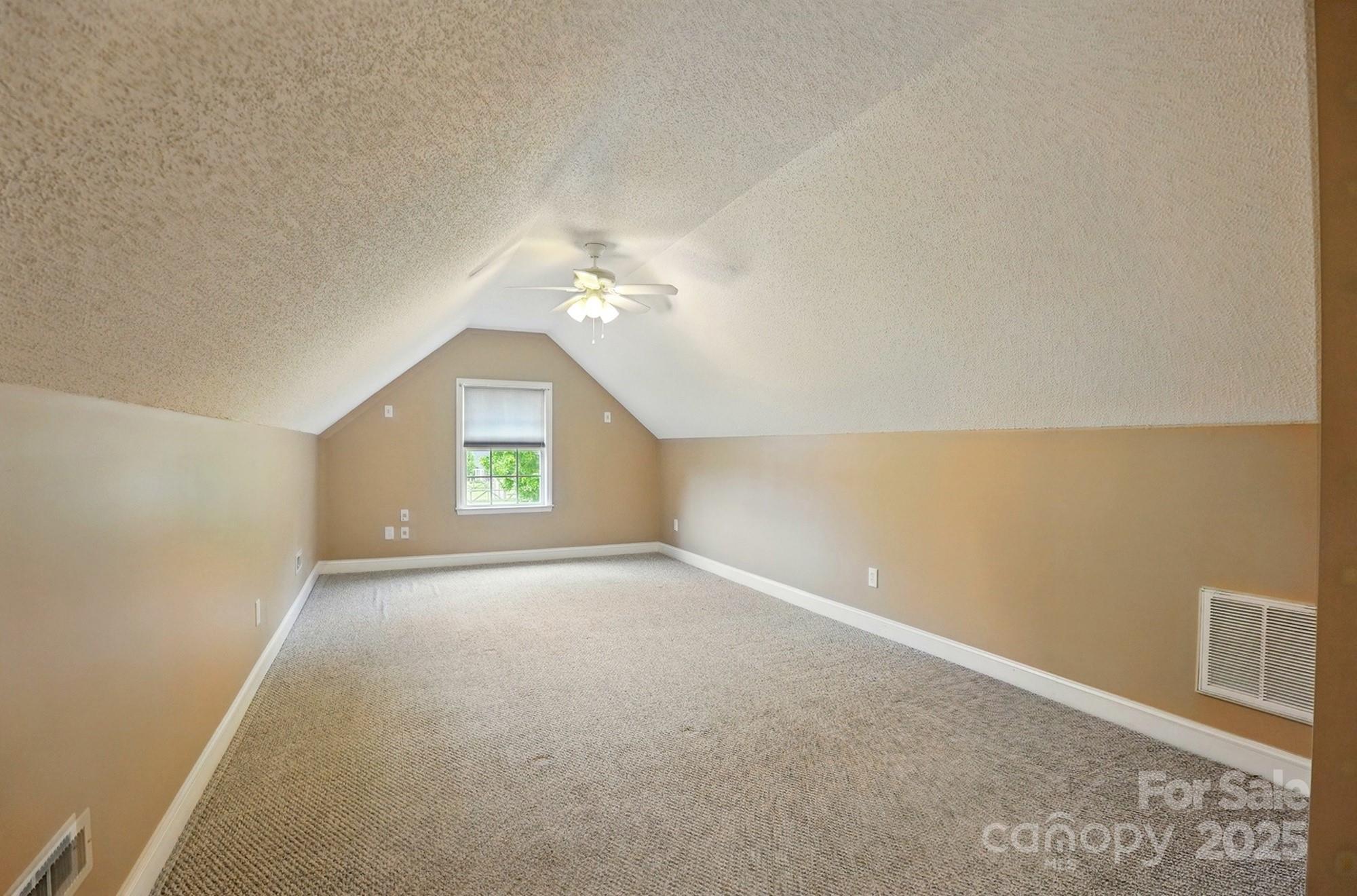 3327 Flagler Circle Midland, NC 28107 - Photo 36 of 45 an empty room with a chandelier fan and window