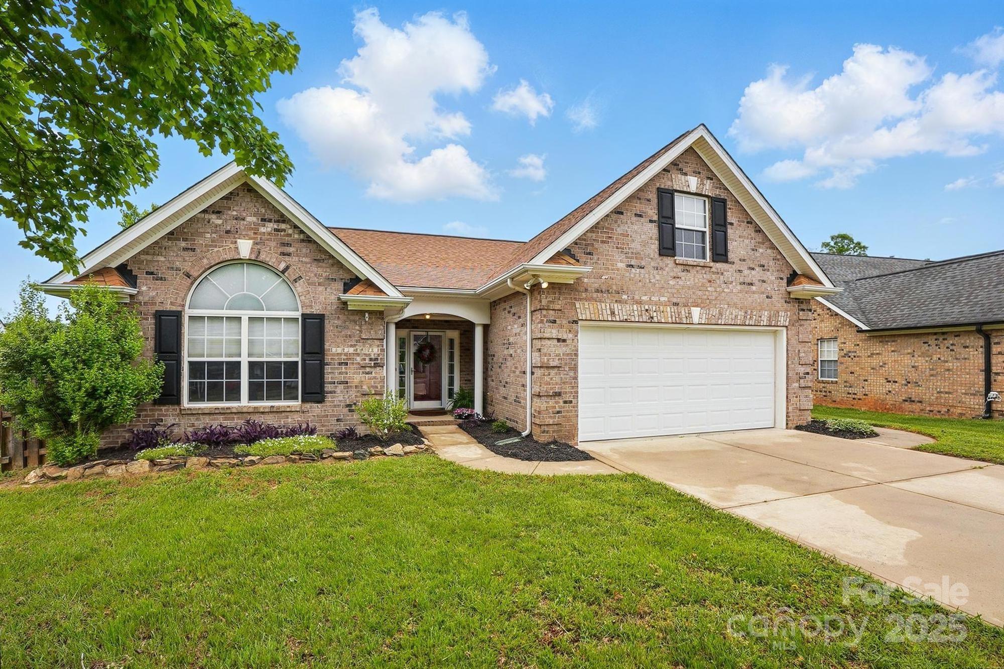 3327 Flagler Circle Midland, NC 28107 - Photo 5 of 45 a front view of a house with a yard and garage