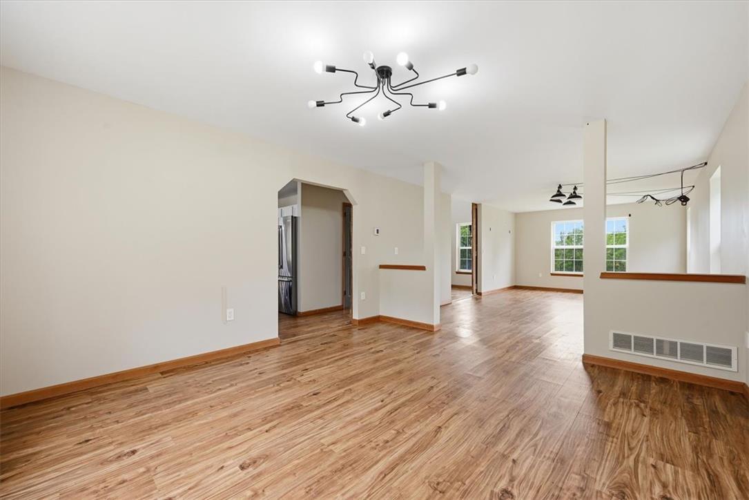 387 Blue Ridge Road Saylorsburg, PA 18353 - Photo 18 of 90 A well-lit interior showcases polished hardwood flooring and contemporary ceiling light fixtures, enhancing an inviting atmosphere.