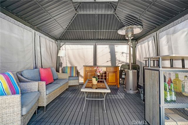 a balcony with furniture and wooden floor