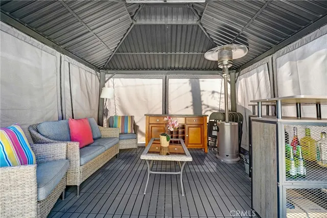 a balcony with furniture and wooden floor