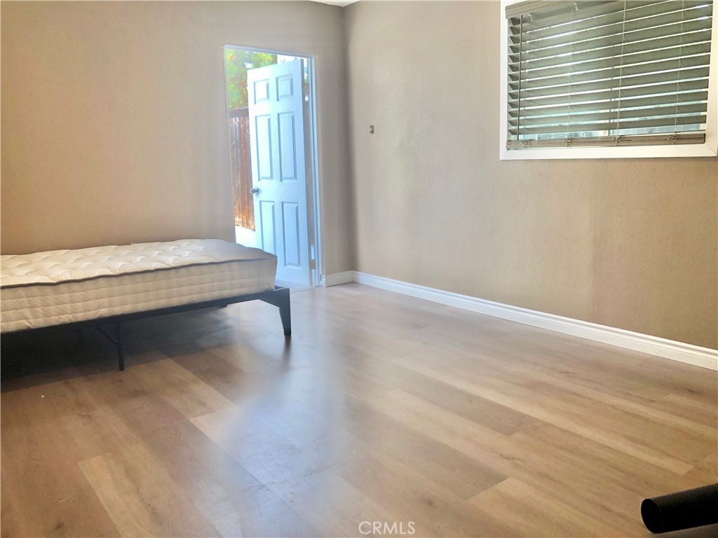 1982 Corson Street Pasadena, CA 91107 - Photo 17 of 30 a view of an empty room with wooden floor and a window