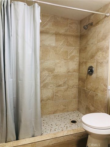 a bathroom with a toilet and shower