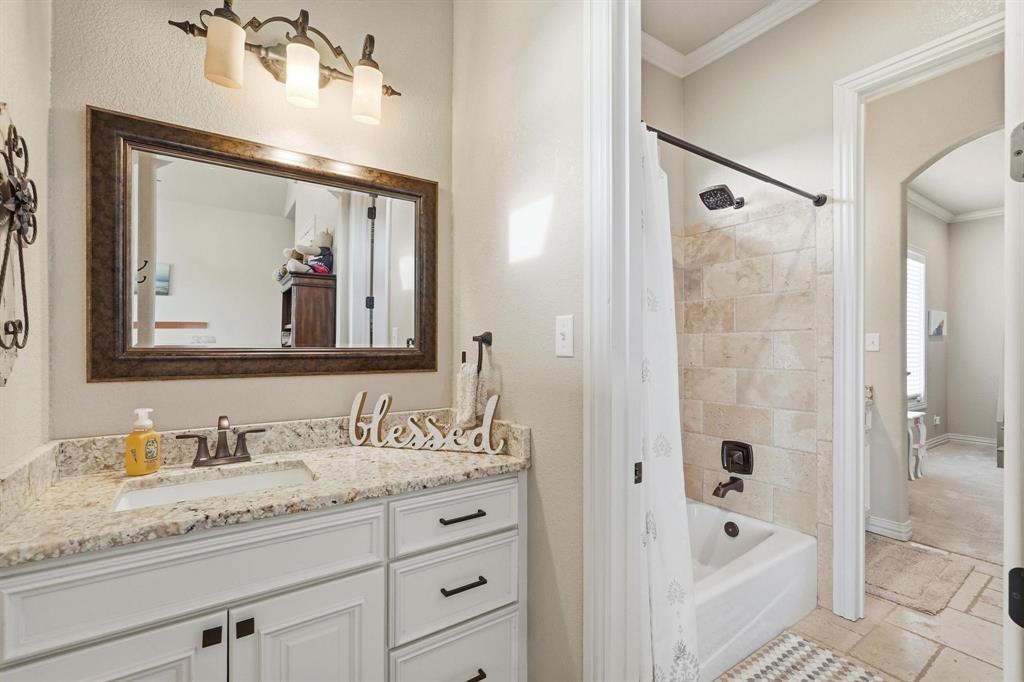 249 Rising Star Drive Abilene, TX 79606 - Photo 23 of 40 a bathroom with a granite countertop sink mirror bathtub and shower
