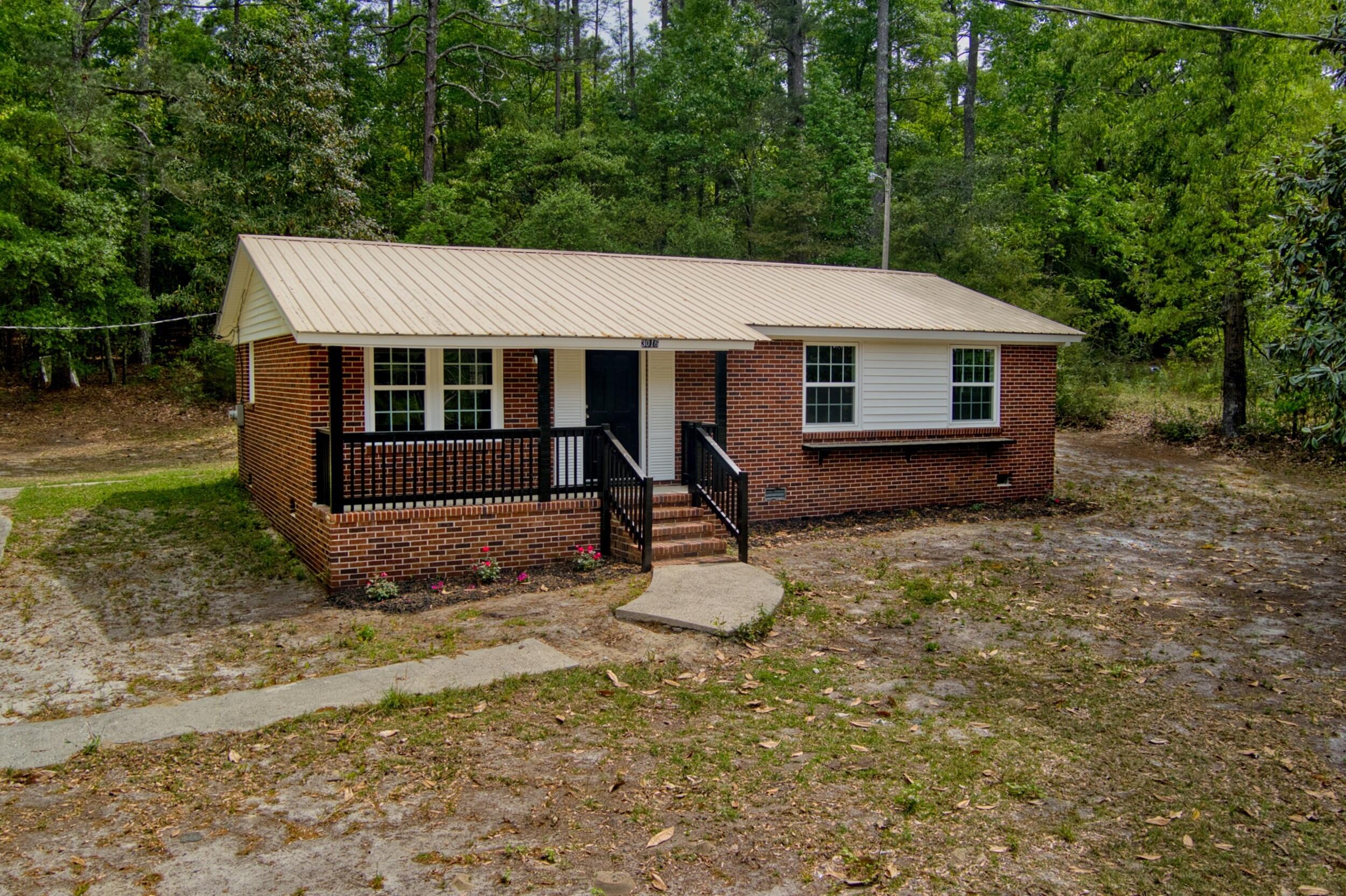 3016 Wagener Road Aiken, SC 29801 - Photo 1 of 29 a backyard of a house with barbeque oven table and chairs