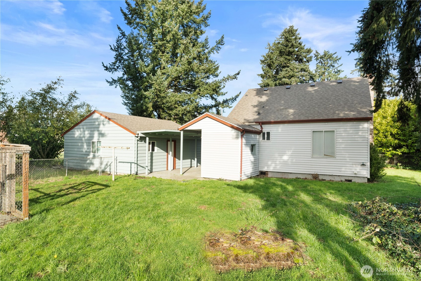 10114 Canyon Road East Tacoma, WA 98446 - Photo 28 of 31 a front view of a house with a yard and trees