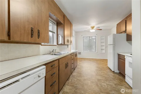a kitchen with a stove oven and sink