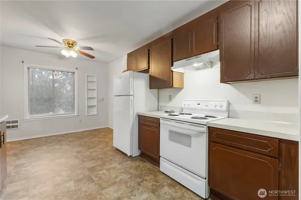 a view of kitchen with furniture and refrigerator