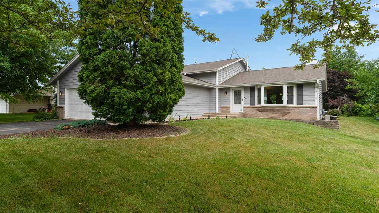 310 Pembroke Road Southwest Poplar Grove, IL 61065 - Photo 1 of 27 a front view of a house with garden