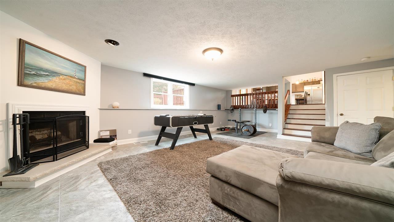 310 Pembroke Road Southwest Poplar Grove, IL 61065 - Photo 11 of 27 a living room with furniture and a fireplace