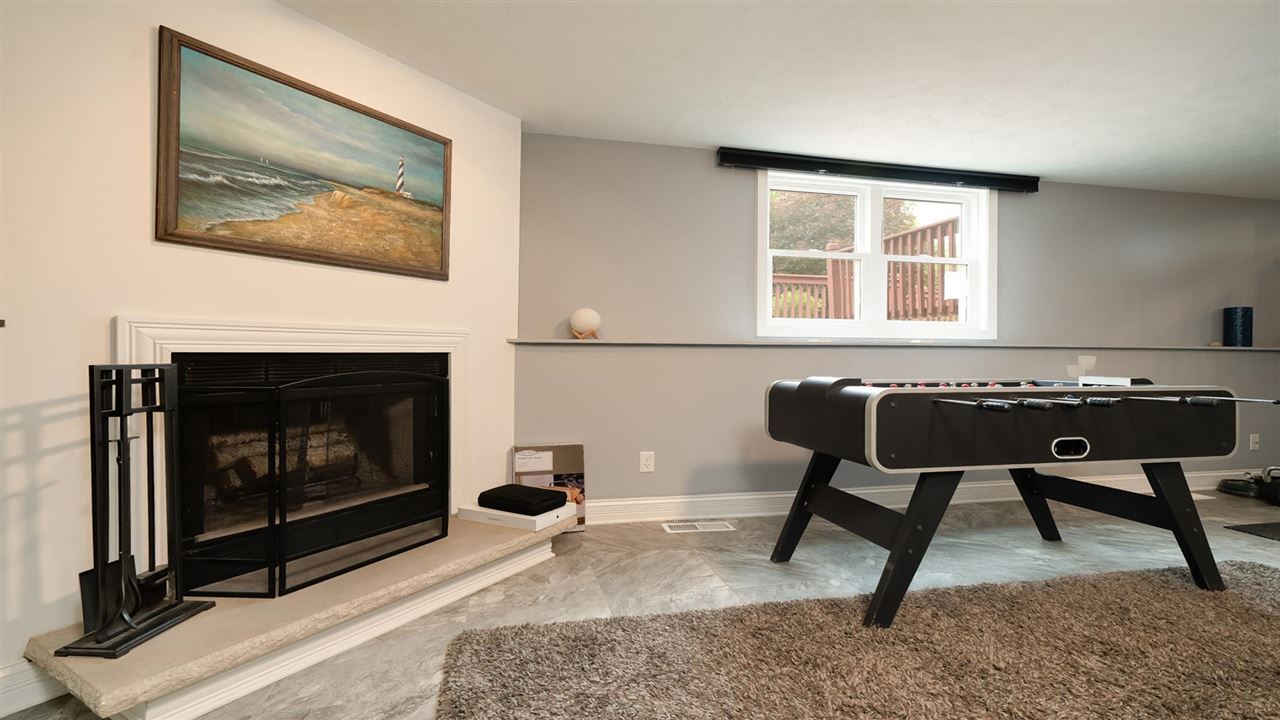 310 Pembroke Road Southwest Poplar Grove, IL 61065 - Photo 13 of 27 a living room with a couch a rug and a fireplace